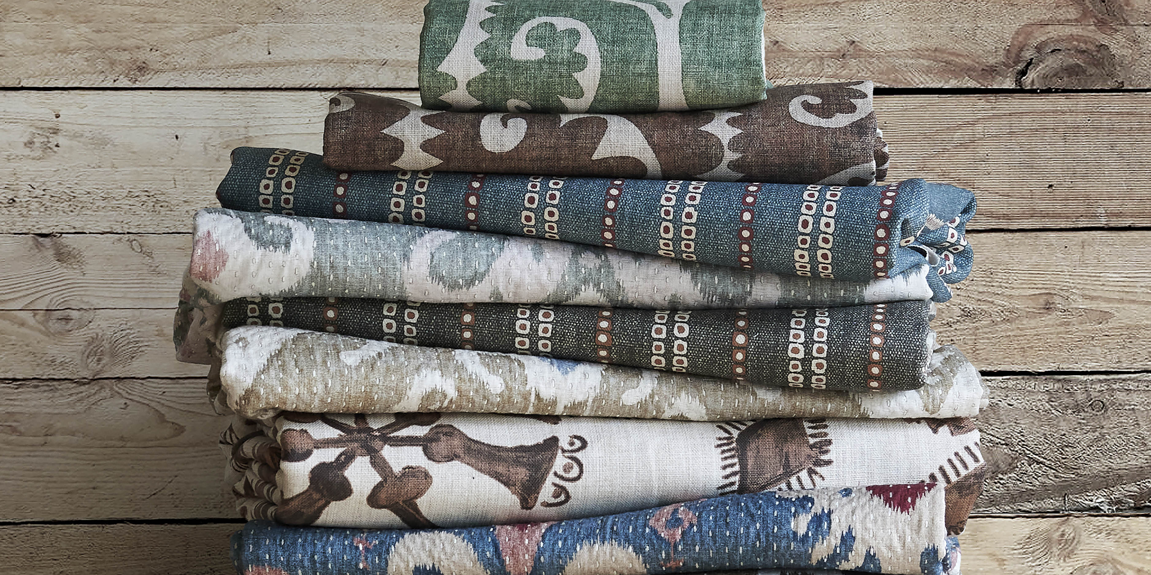 lewis and wood pile of folded fabric